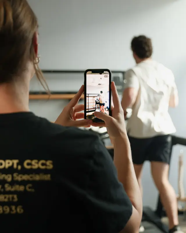 Dr. Kiley films a runner on the treadmill with her phone to study his stride