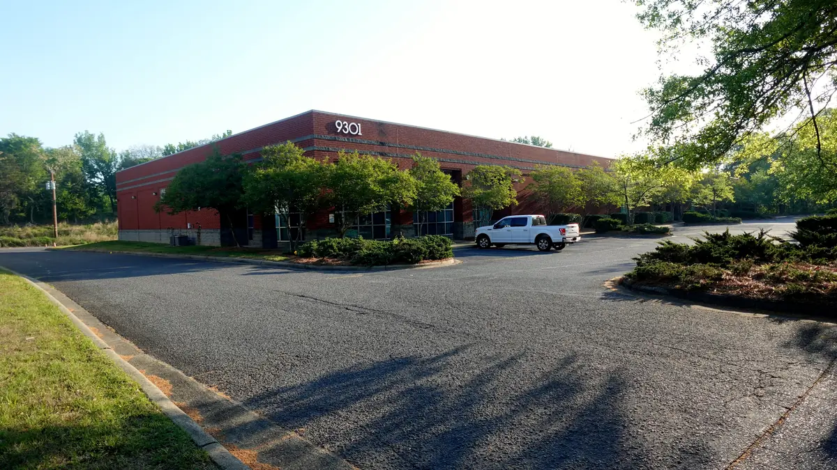 The brick building at 9301 Forsyth Park Drive in Steele Creek, with its parking lot